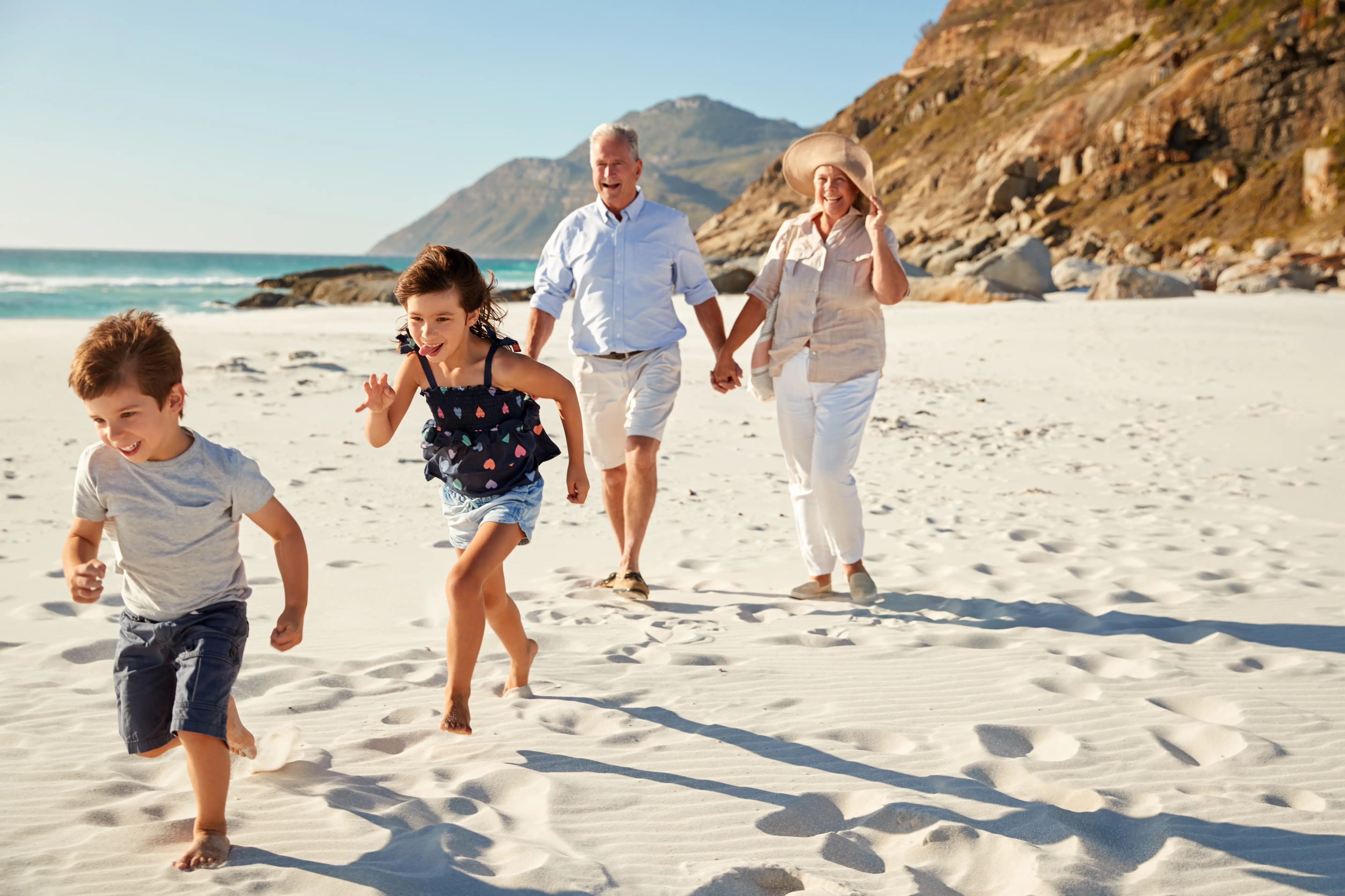 Family protected by private health insurance enjoying the beach together — cover for all ages from an independent UK broker